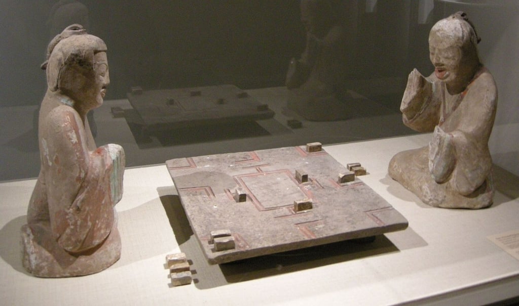This exceptional Han dynasty (202 BC-220) earthenware sculpture at The Met captures two figures completely absorbed in a tense game of Liubo. Photo: Wikipedia