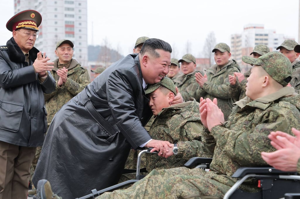 North Korean leader Kim Jong-un embraces injured soldiers after their return from deployment in Russia’s Kursk region in December. Photo: KCNA/KNS/AFP