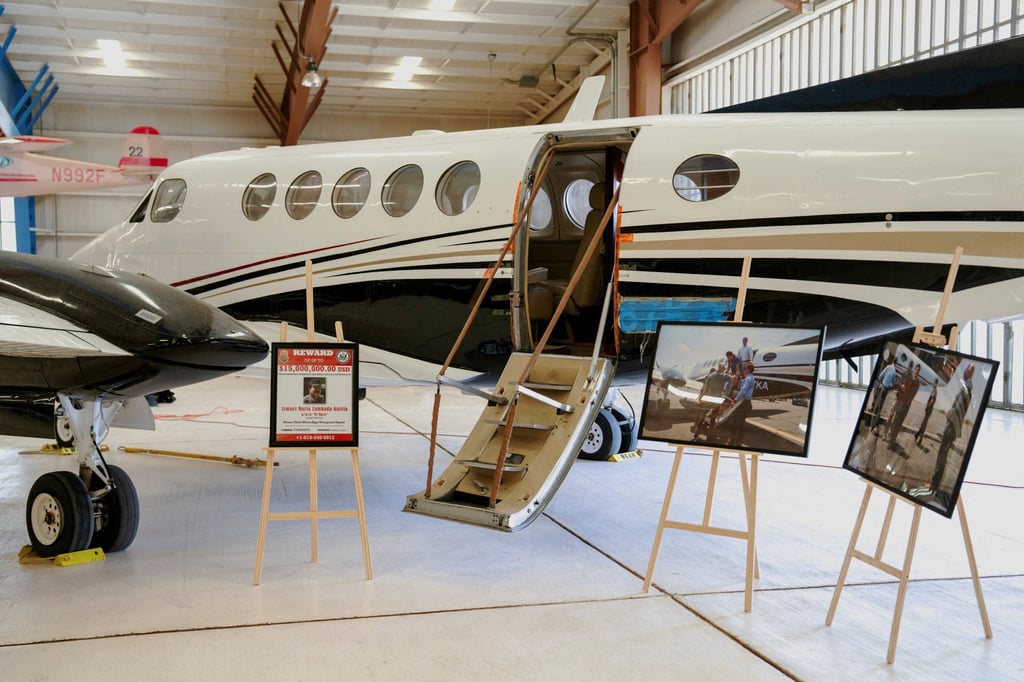 An aircraft, used in July 2024 to transport cartel leaders Ismael “El Mayo” Zambada and Joaquin Guzman Lopez, the son of notorious narco leader “El Chapo” Guzman, is displayed with photos from the operation that led to their capture at the War Eagles Air Museum in New Mexico, on July 9. Photo: Reuters