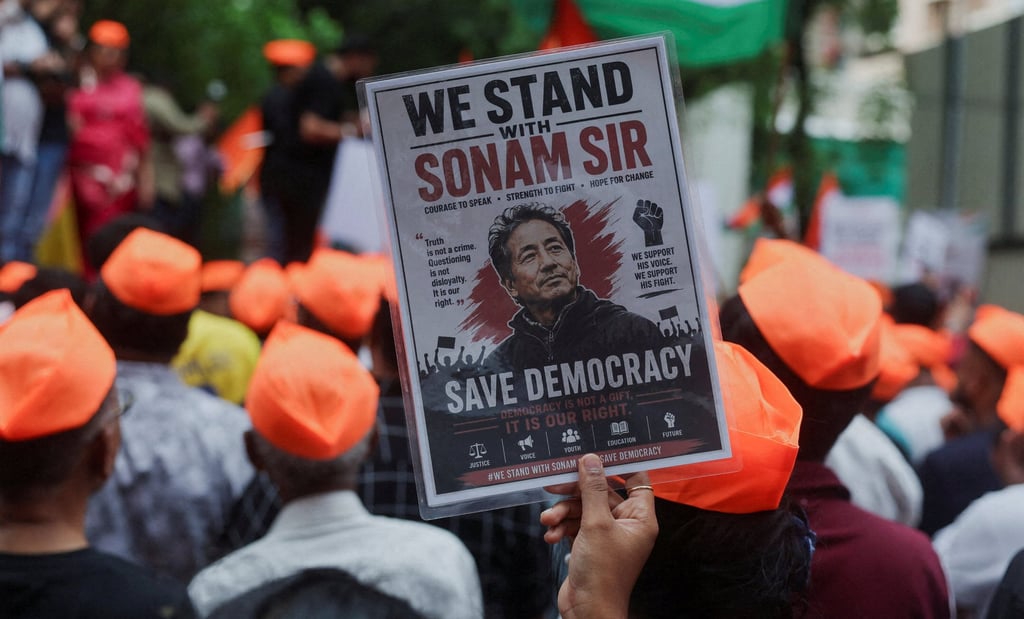 A CJP supporter holds a poster of Sonam Wangchuk on Sunday after authorities move him to a hospital during his hunger strike. Photo: Reuters