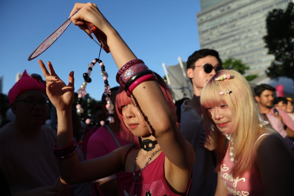 Young attendees shield themselves from the sun at last month’s Pink Dot SG pride event in Singapore. Photo: EPA
