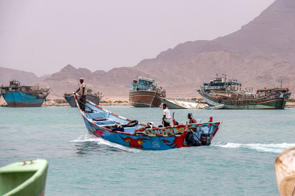 People sit in a fishing boat sailing the Bab el-Mandeb Strait off Yemen’s southern Taiz province on Saturday. Photo: AFP