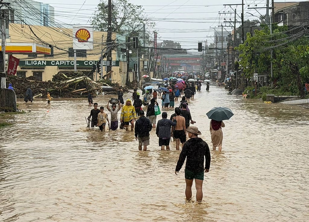 People wade through floodwaters brought by Tropical Storm Penha in Iligan, the Philippines’ Lanao del Norte province, on February 6. Photo: AFP