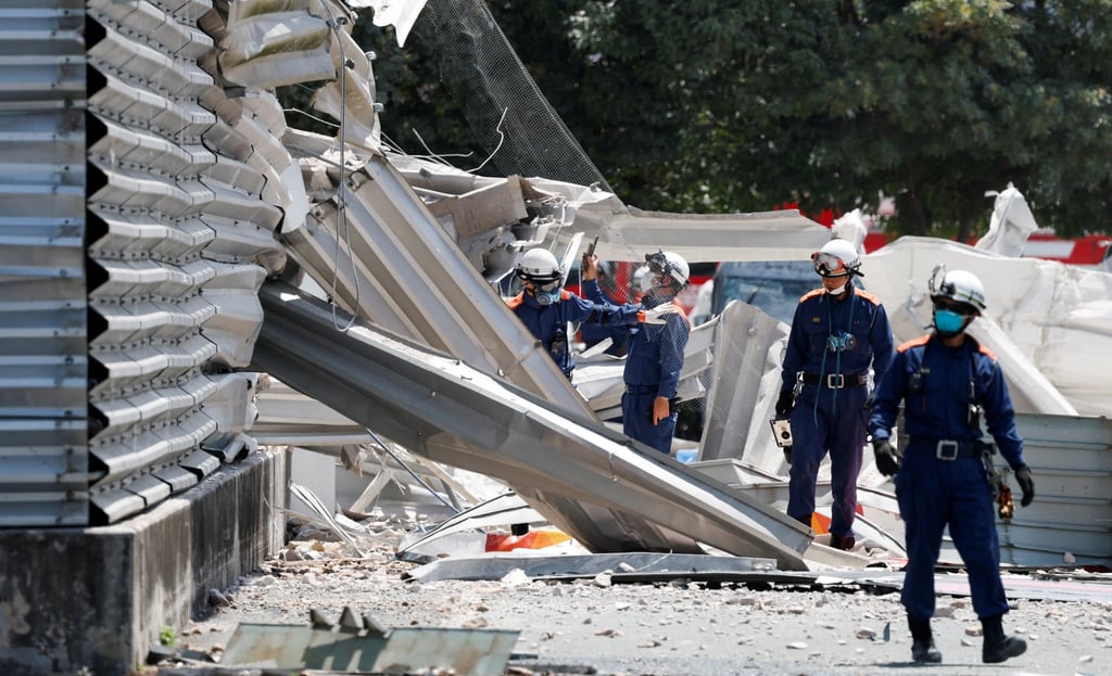 Emergency workers inspect the damaged Aeon Mall on Wednesday. Photo: Reuters