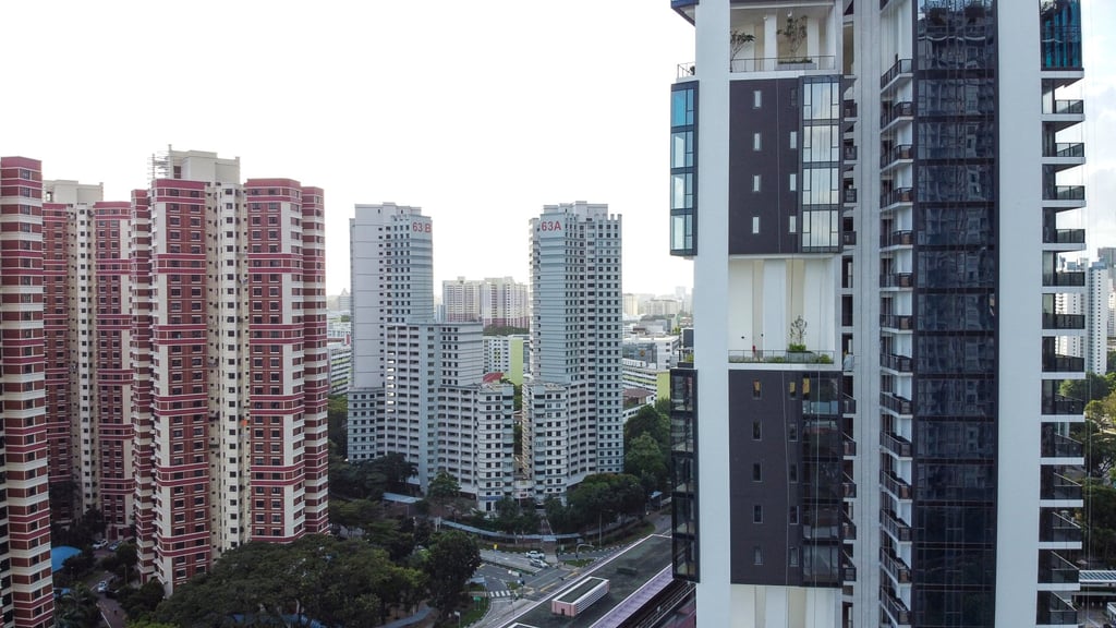 HDB public housing blocks (left) and private residential buildings seen side by side in Singapore. Photo: Roy Issa