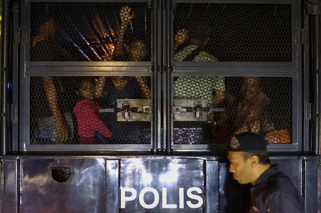 Rohingya refugees inside a truck as they are taken by police, in front of the office of the UN Refugee Agency, after being evicted from their homes, in Kuala Lumpur, Malaysia, on Monday. Photo: Reuters
