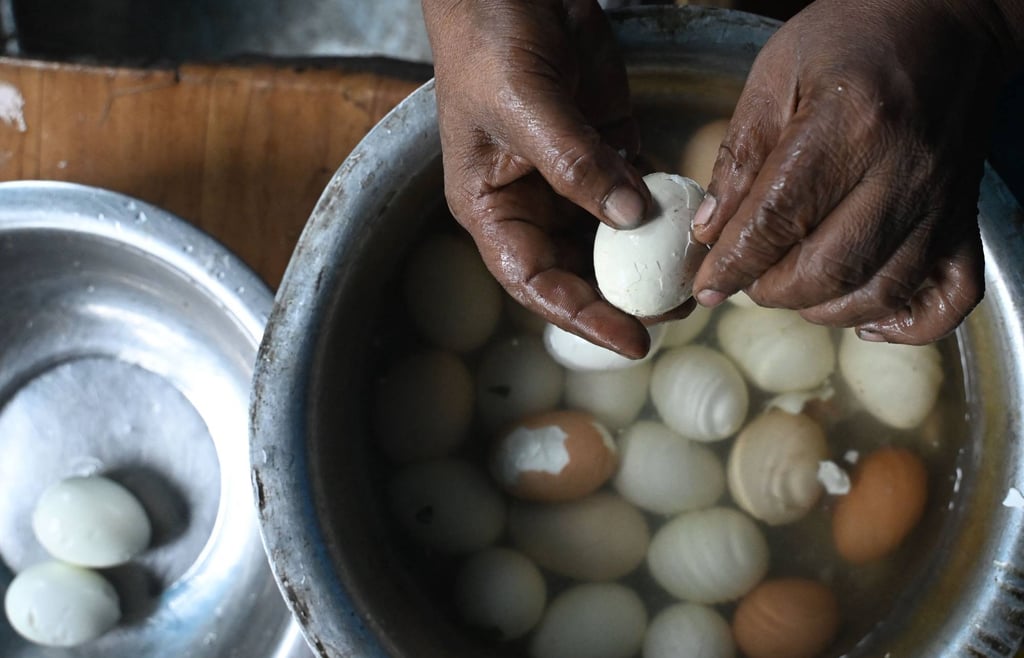 A shopkeeper prepares boiled eggs at his roadside stall in Kolkata on July 10. Eggs, which Hindus consider non-vegetarian, are widely consumed in India. Photo: AFP