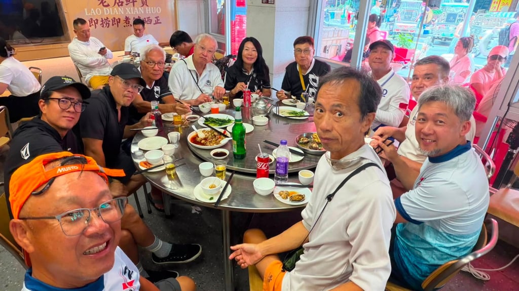 Thomas Wong (rear, black shirt) and his friends enjoy a seafood feast on Guishan Island. Photo: Handout