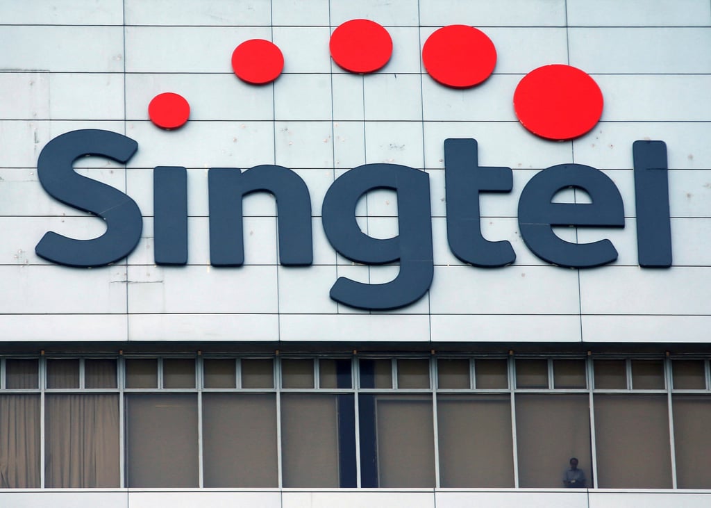 A man looks out of the window of Singtel’s head office in Singapore. Photo: Reuters