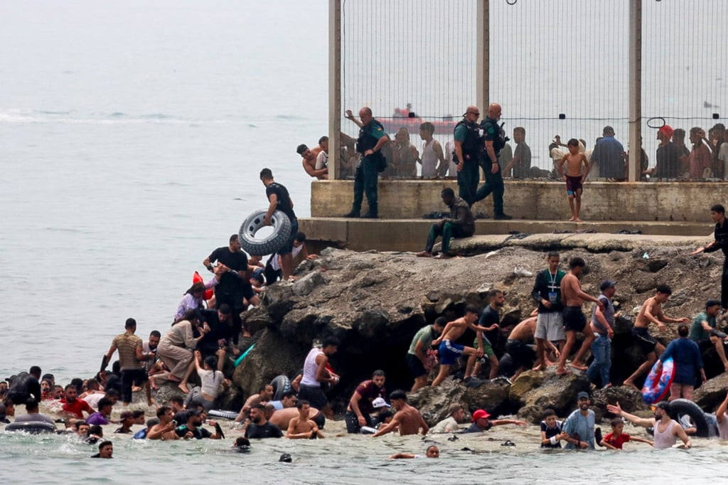 Migrants reach Spanish territory after swimming from Morocco to Ceuta on Thursday. Photo: EPA