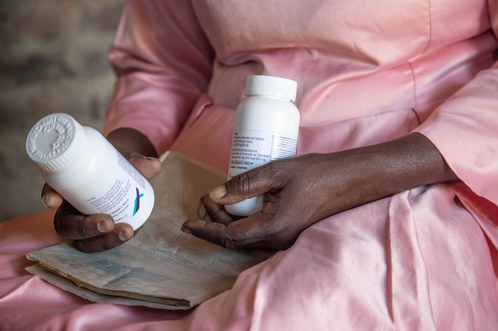 A woman holds HIV medication that she received through funding from PEPFAR at her home in Harare, Zimbabwe, in February 2025. Photo: AP
