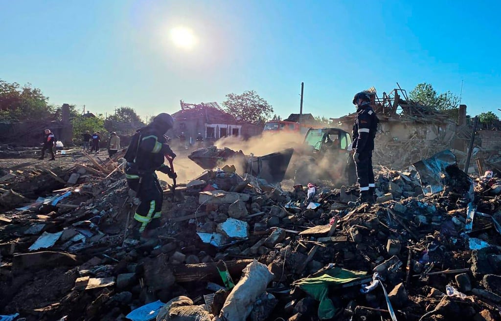 Ukrainian rescuers work in the rubble of a destroyed house following an air attack in Radushne on Thursday. Photo: Dnipropetrovsk Regional Military Administration via AFP