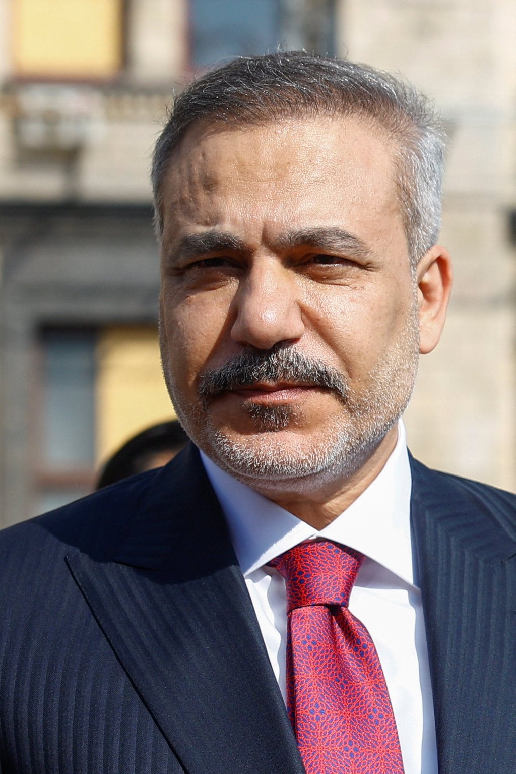 Turkish Foreign Minister Hakan Fidan looks on during a visit to a makeshift memorial to fallen Ukrainian defenders in Kyiv, Ukraine, on July 16. Photo: Reuters