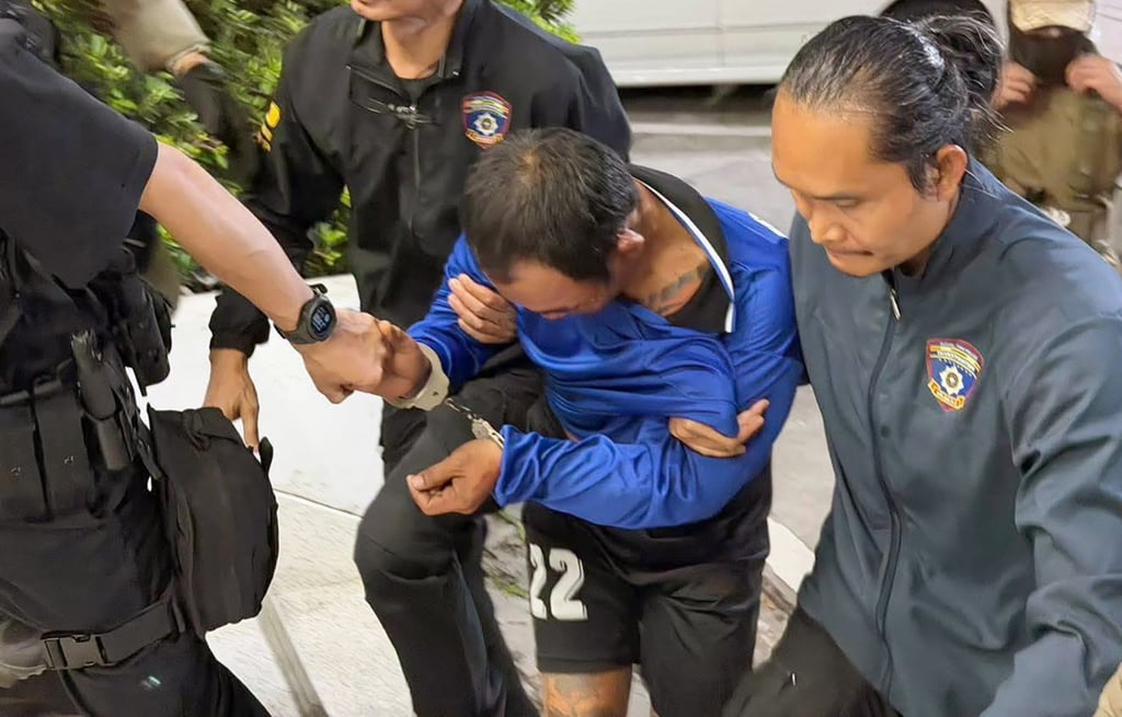 Thana Kerdthong is brought in for investigation at the Huayyai police station in Chonburi province on Friday. Photo: Royal Thai Police/EPA