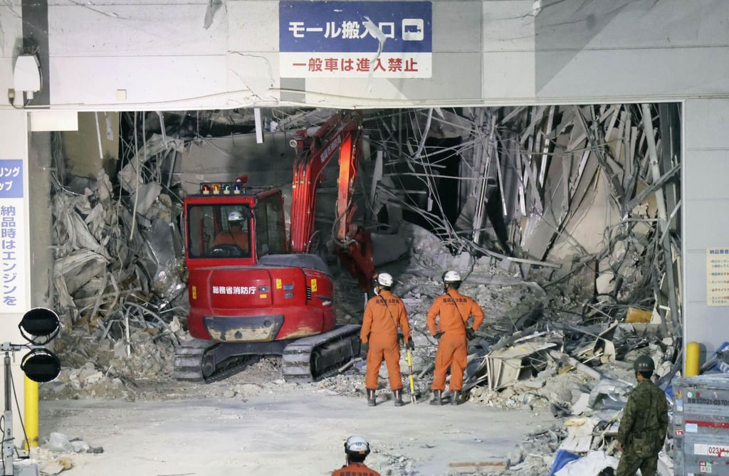 Heavy machinery removes debris at Aeon Mall Kumamoto on Friday. Photo: Kyodo/AP