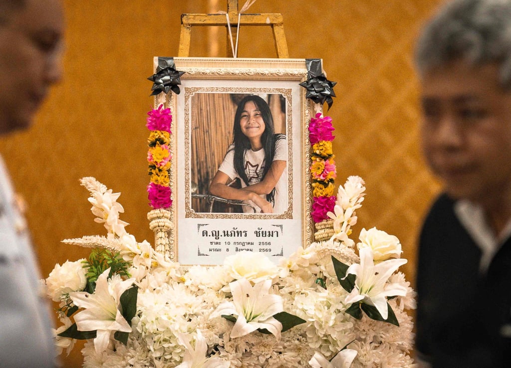 A portrait of 12-year-old school shooting victim Naphat Chaima is displayed in front of the coffin during her funeral at the Wat Lat Pla Duk Buddhist temple in Nonthaburi province on Sunday. Photo: AFP