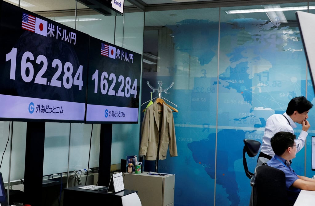 Employees at exchange trading company Gaitame.com work in front of monitors displaying the yen-to-dollar rate in Tokyo, Japan, on June 30. Photo: Reuters