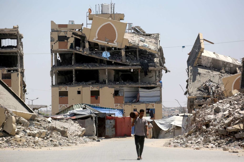 An internally displaced Palestinian man walks past the rubble of buildings destroyed by the Israeli military in Khan Younis on Tuesday. Photo: AFP