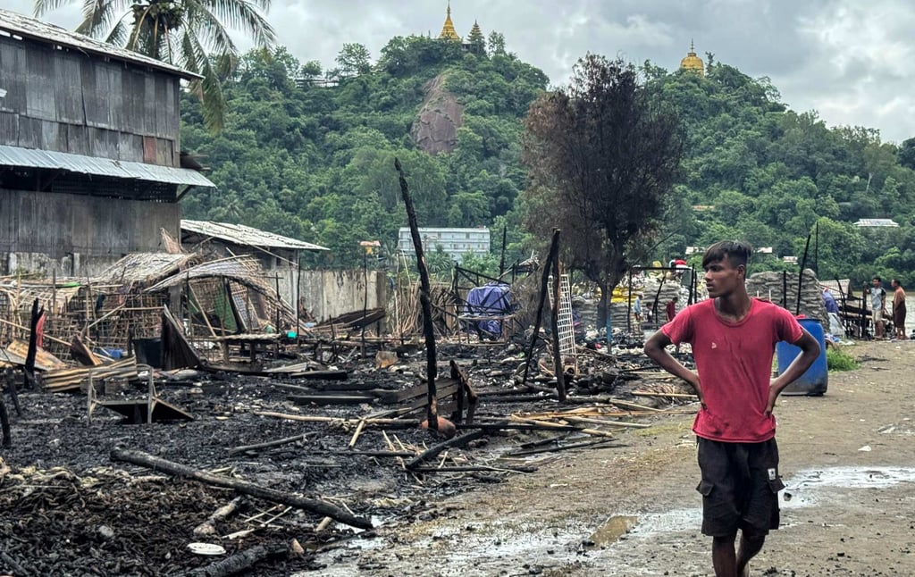 A man walks past the ruins of a building after an air strike by Myanmar’s military in Kyauktaw, western Rakhine State on June 18. Photo: AFP