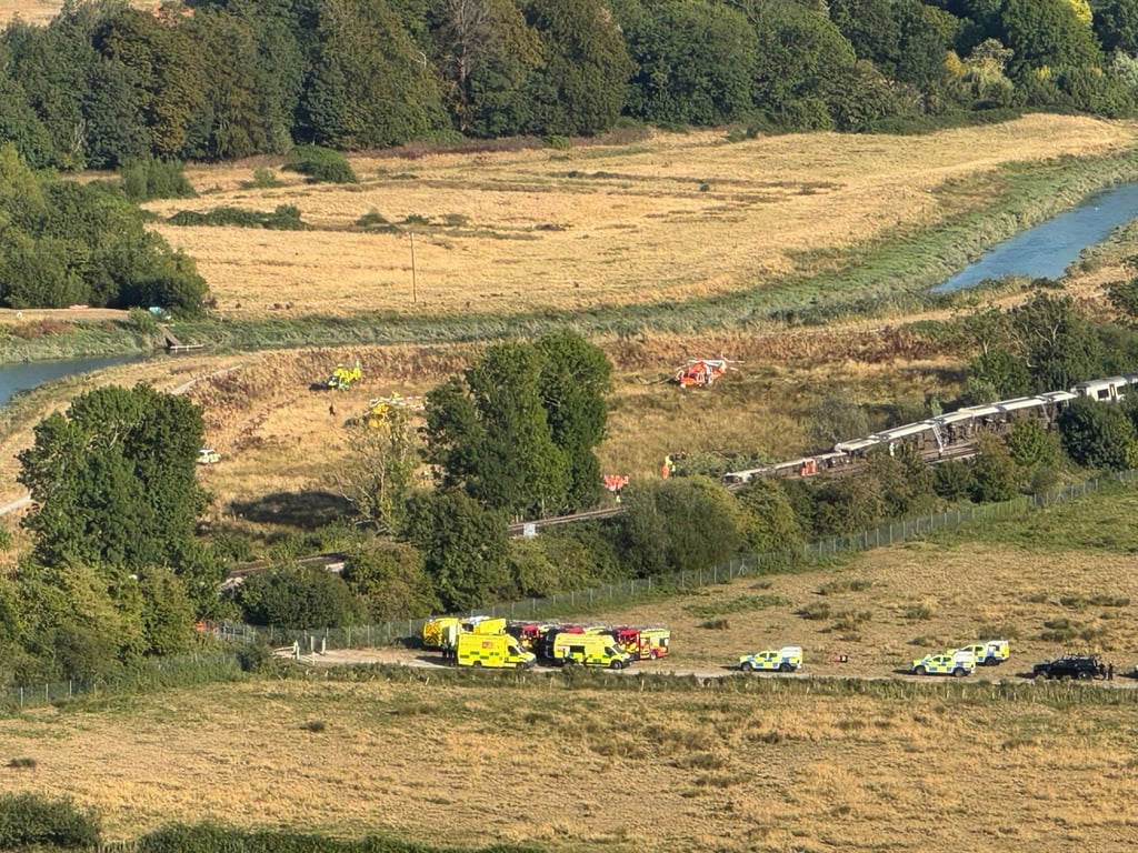 Emergency vehicles arrive at the scene of a train derailment near Lewes in East Sussex on Thursday. Photo: PA Wire via dpa