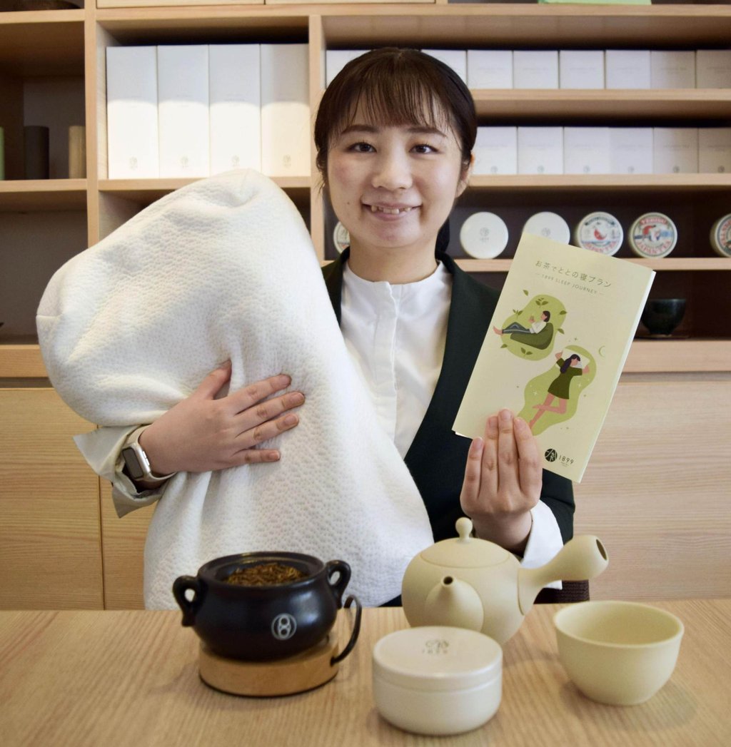 Hotel 1899 Tokyo’s Yuiko Ogawa holds a leaflet and a high-performance pillow used for its totono-ne sleep plan in Tokyo in July. Photo: Kyodo