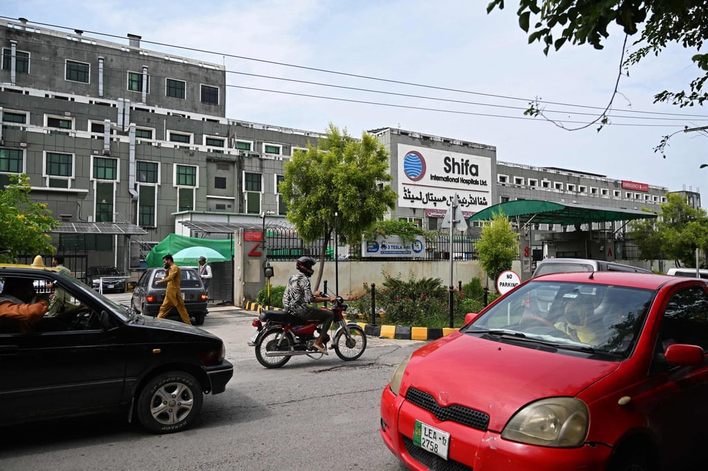 Commuters ride past the Shifa International Hospital in Islamabad on Tuesday, after Pakistan’s Supreme Court ordered jailed former prime minister Imran Khan’s transfer from prison for medical treatment. Photo: AFP