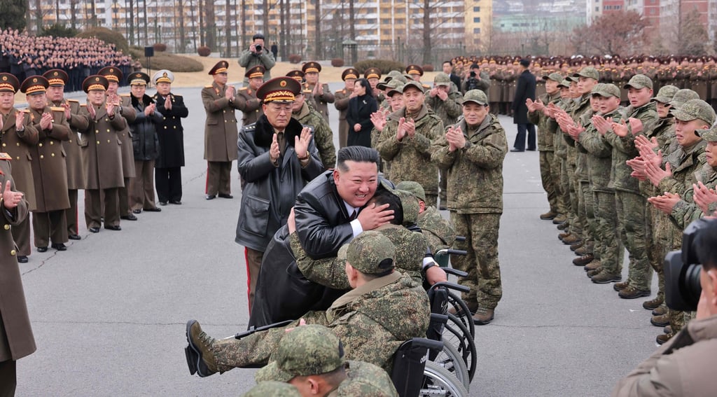 North Korean leader Kim Jong-un welcomes soldiers who returned from an overseas deployment in Russia’s Kursk region during Moscow’s war with Ukraine, in Pyongyang in December 2025. Photo: KCNA via KNS / AFP