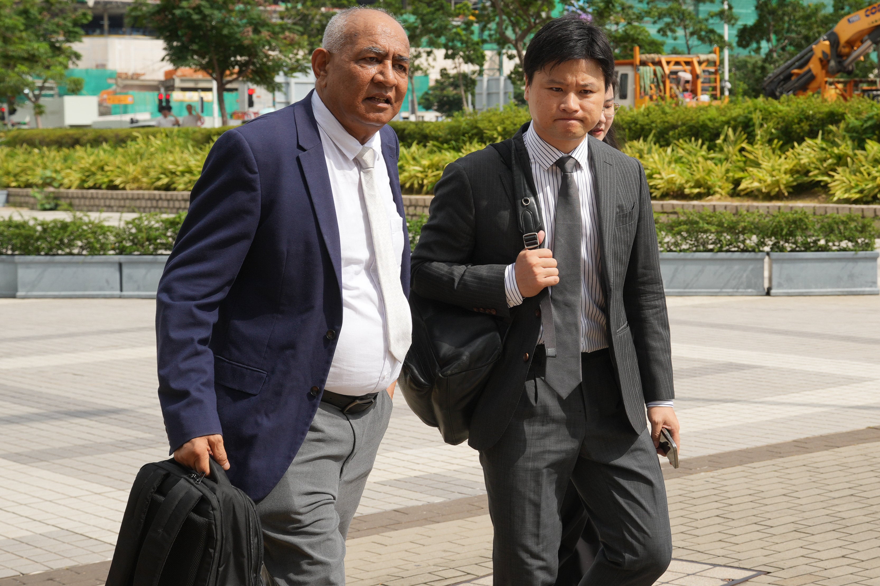 Professors Asif Usmani (left) and Jiang Liming of Polytechnic University arrive at City Gallery in Central for the hearing. Photo: May Tse