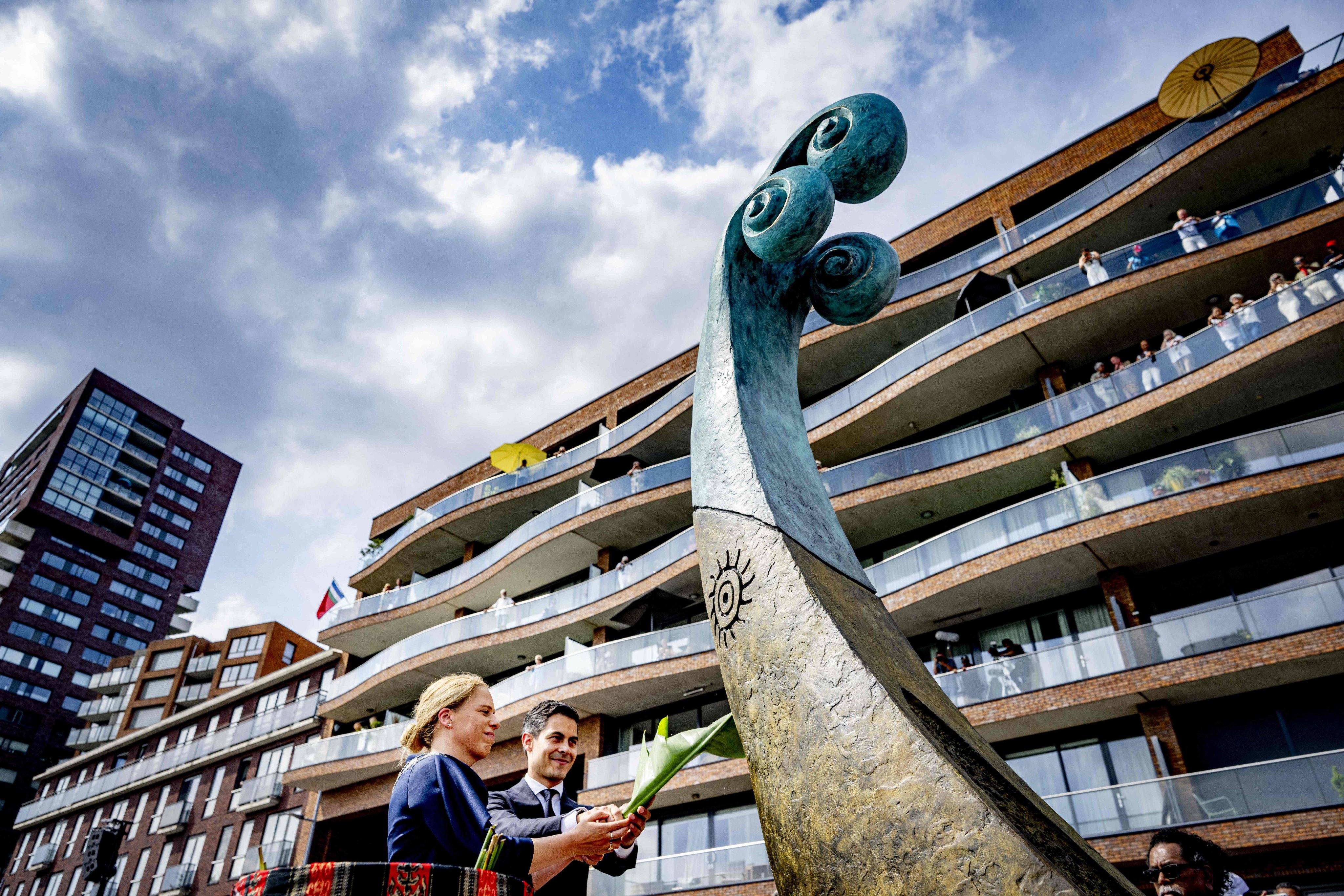 The Netherlands’ Prime Minister Rob Jetten (centre) and Mayor of Rotterdam Carola Schouten (left) unveil a national monument at the Lloydkade for Malukans in Rotterdam on June 21. Photo: AFP