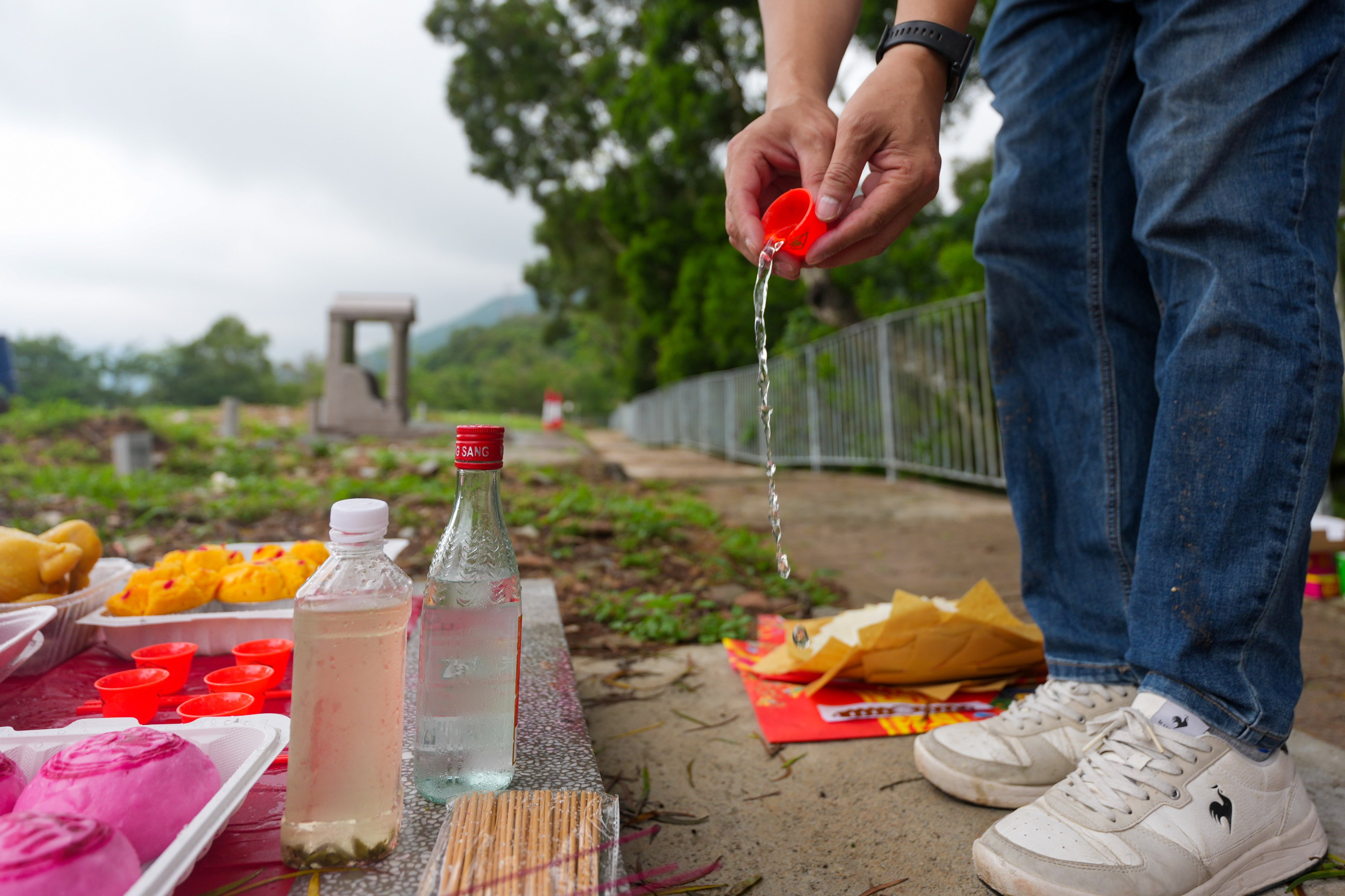 A family member performs rituals during a Taoist funeral for a victim of the Wang Fuk Court fire. Photo: Karma Lo