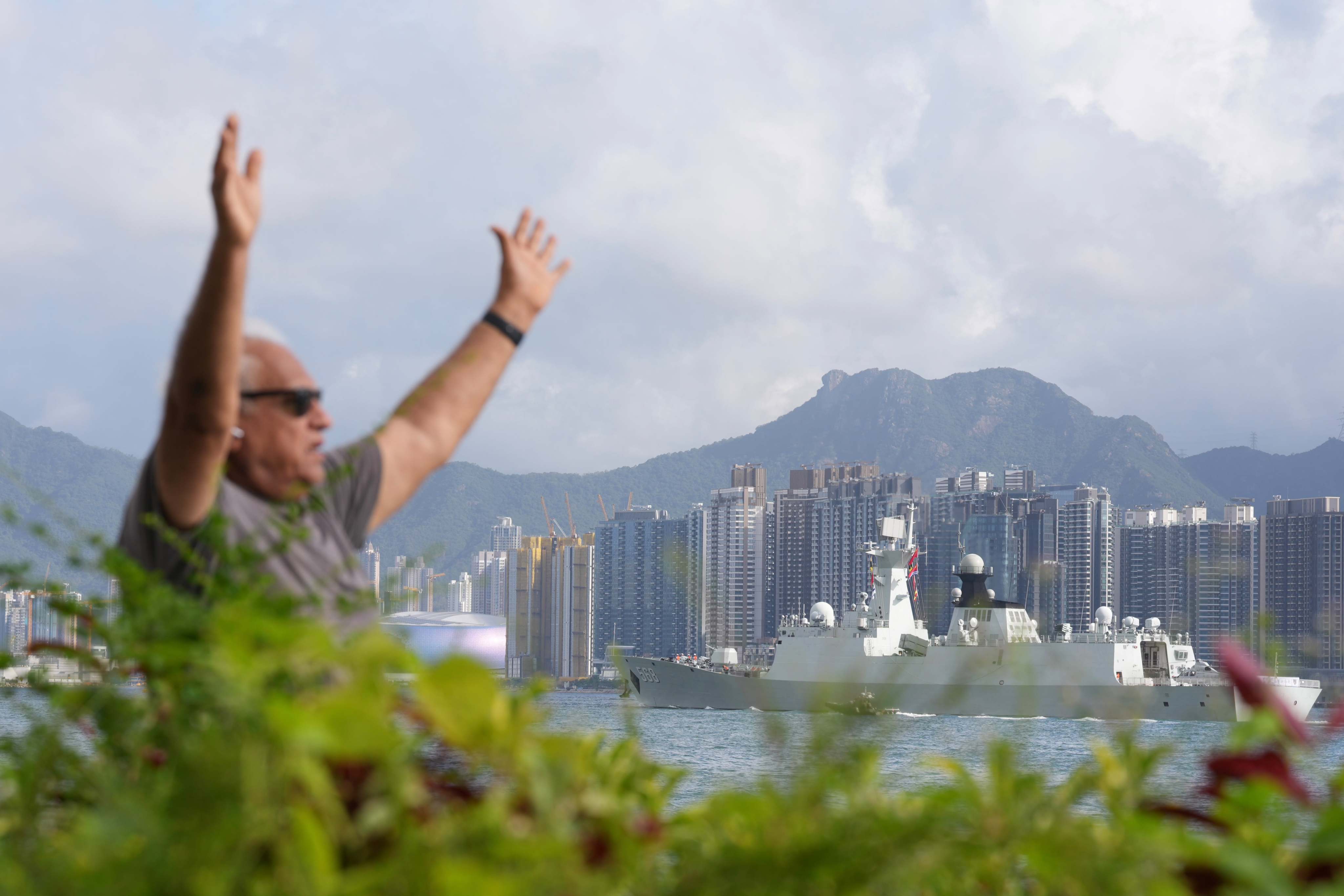 A resident at the Sai Wan Ho promenade, with the PLA guided-missile destroyer Nanning in the background. Photo: Karma Lo