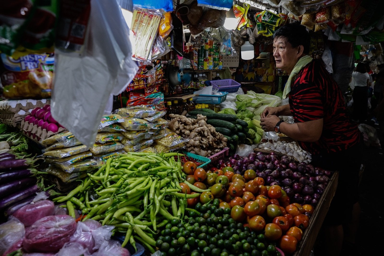 A vendor tends to his market stall in Quezon City, Metro Manila, last month. Inflation in the Philippines eased slightly to 6.8 per cent in May from 7.2 per cent in April. Photo: EPA