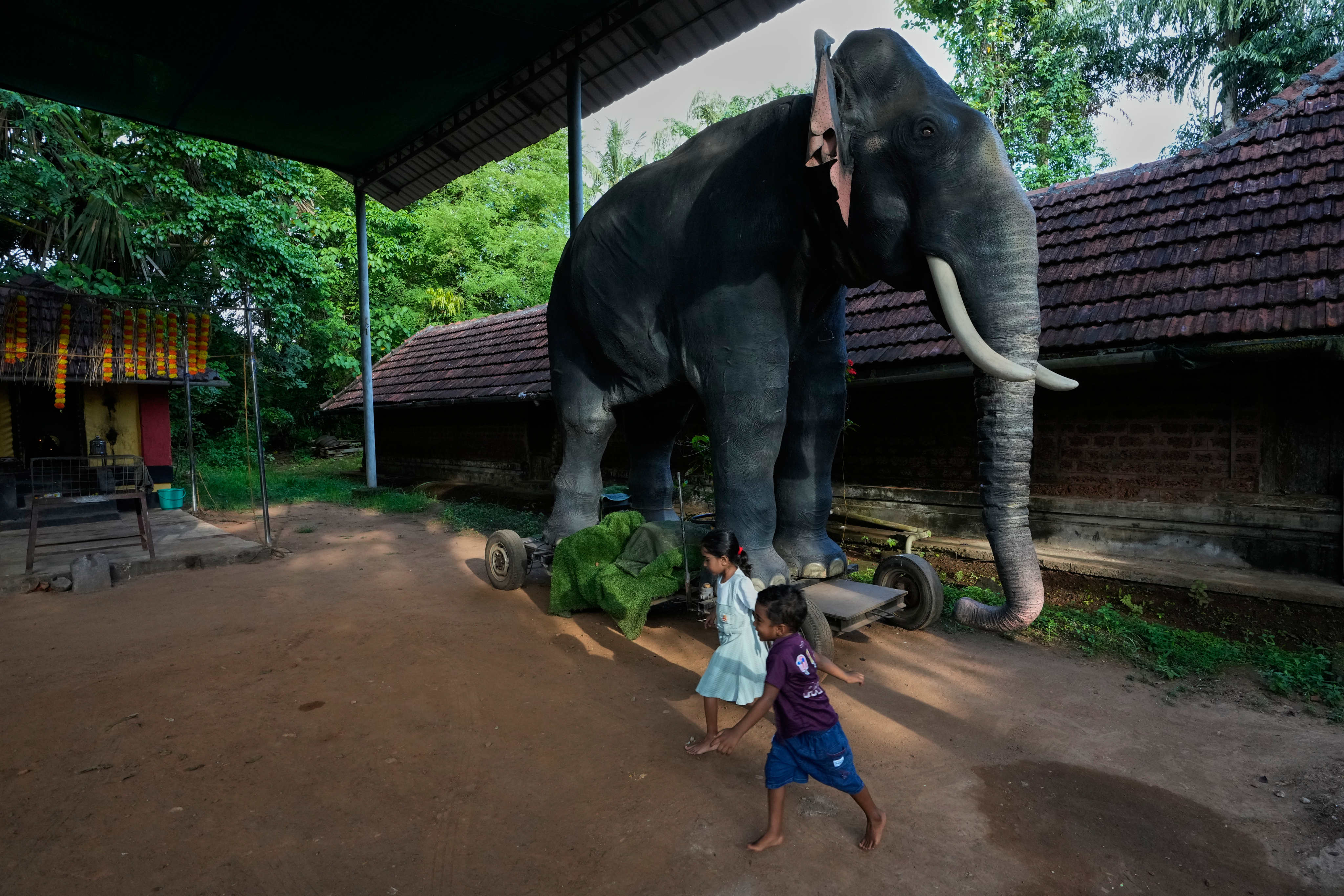 Children play next to motionless Irinjadapilly Raman, a robotic elephant, at Irinjadapilly Sree Krishna Temple in Thrissur, in the southern Indian state of Kerala, in May. Photo: AP