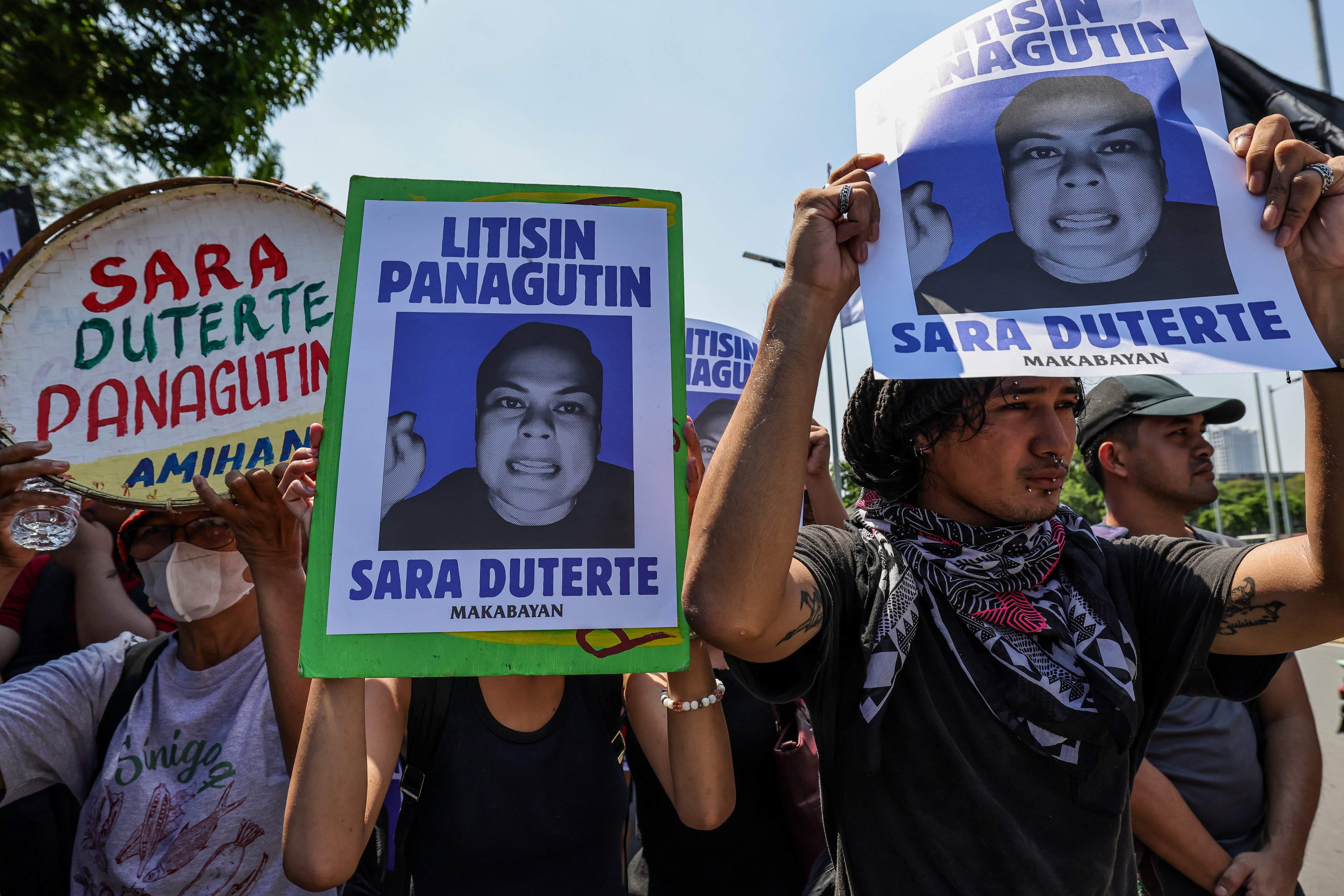 Protesters against Philippine Vice-President Sara Duterte-Carpion carry posters bearing her photo during a rally near the Senate in Pasay city on Monday. Photo: AP