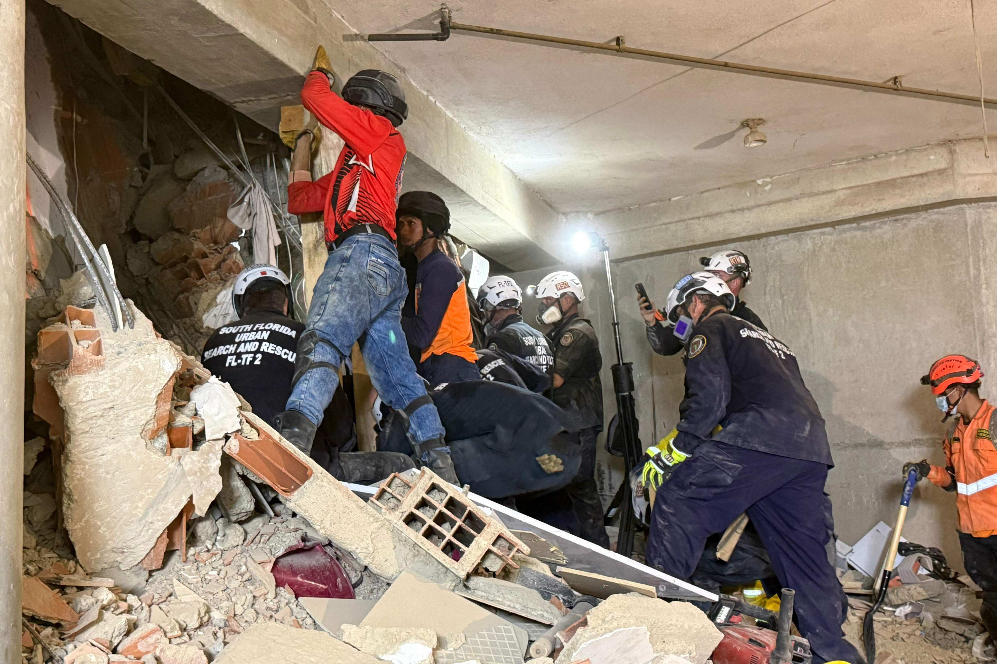 Rescuers working to save Hernan Gil. Photo: City of Miami Fire-Rescue via AFP