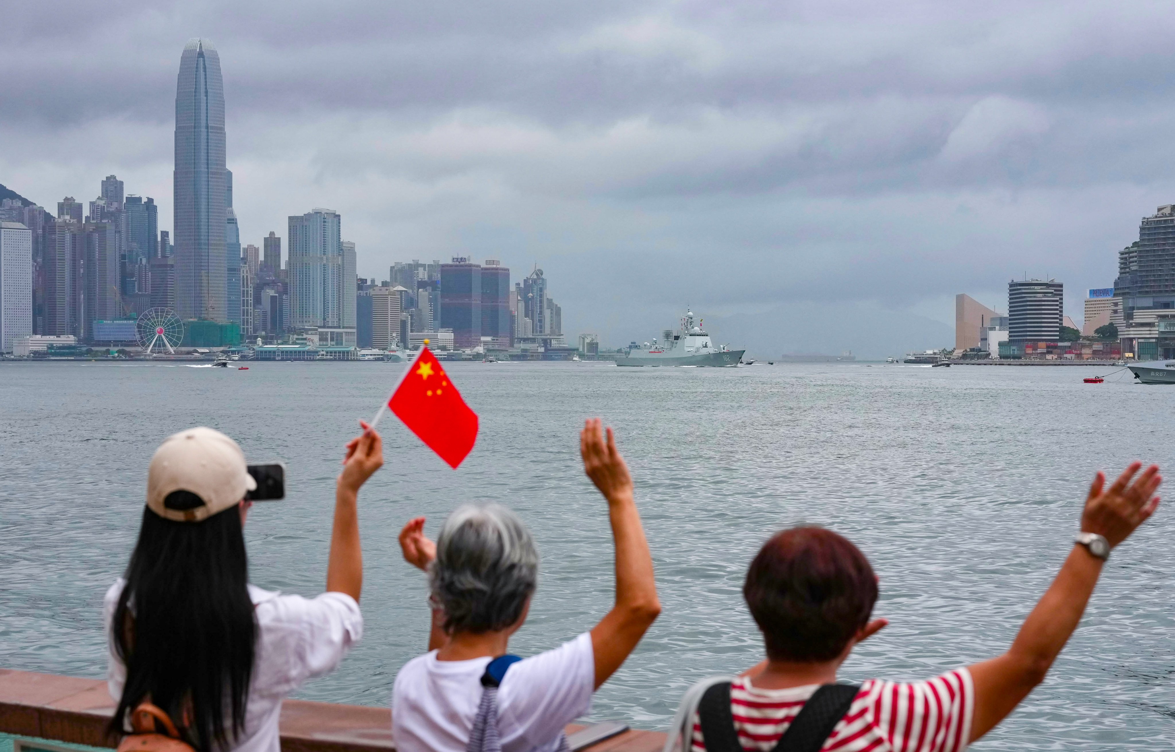 People wave goodbye as PLA warships depart Hong Kong. Photo: Karma Lo