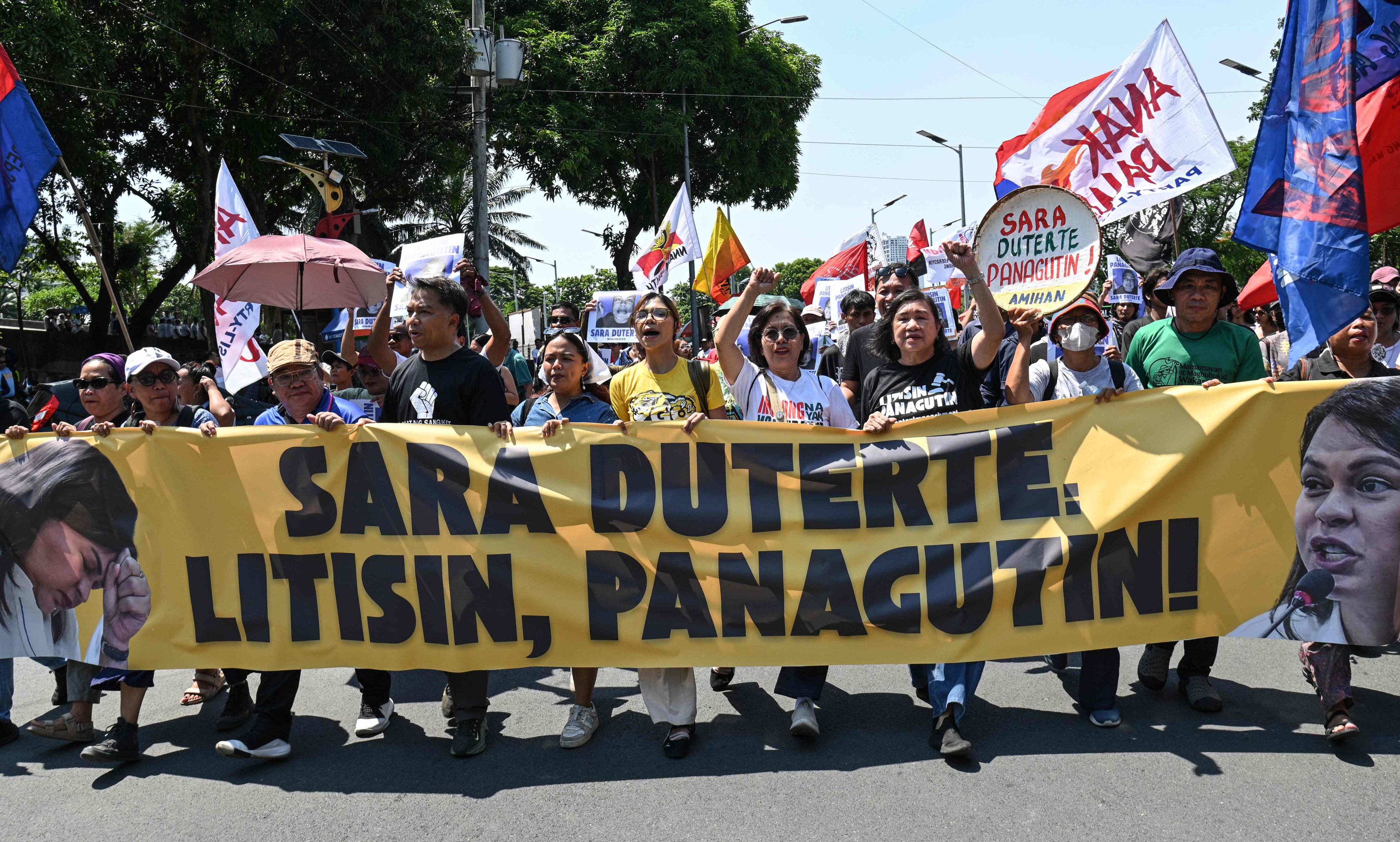 Protesters from progressive groups carrying a banner that reads “Sara Duterte should be tried, held accountable” as they march towards the Senate in Manila, the Philippines, on Monday, on the first day of Duterte’s impeachment trial. Photo: AFP