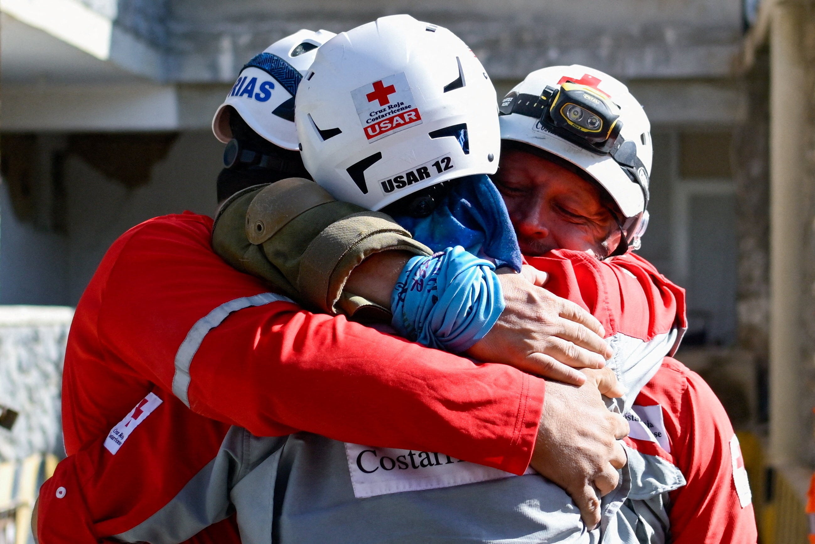 Rescuers hug after their success. Photo: Reuters