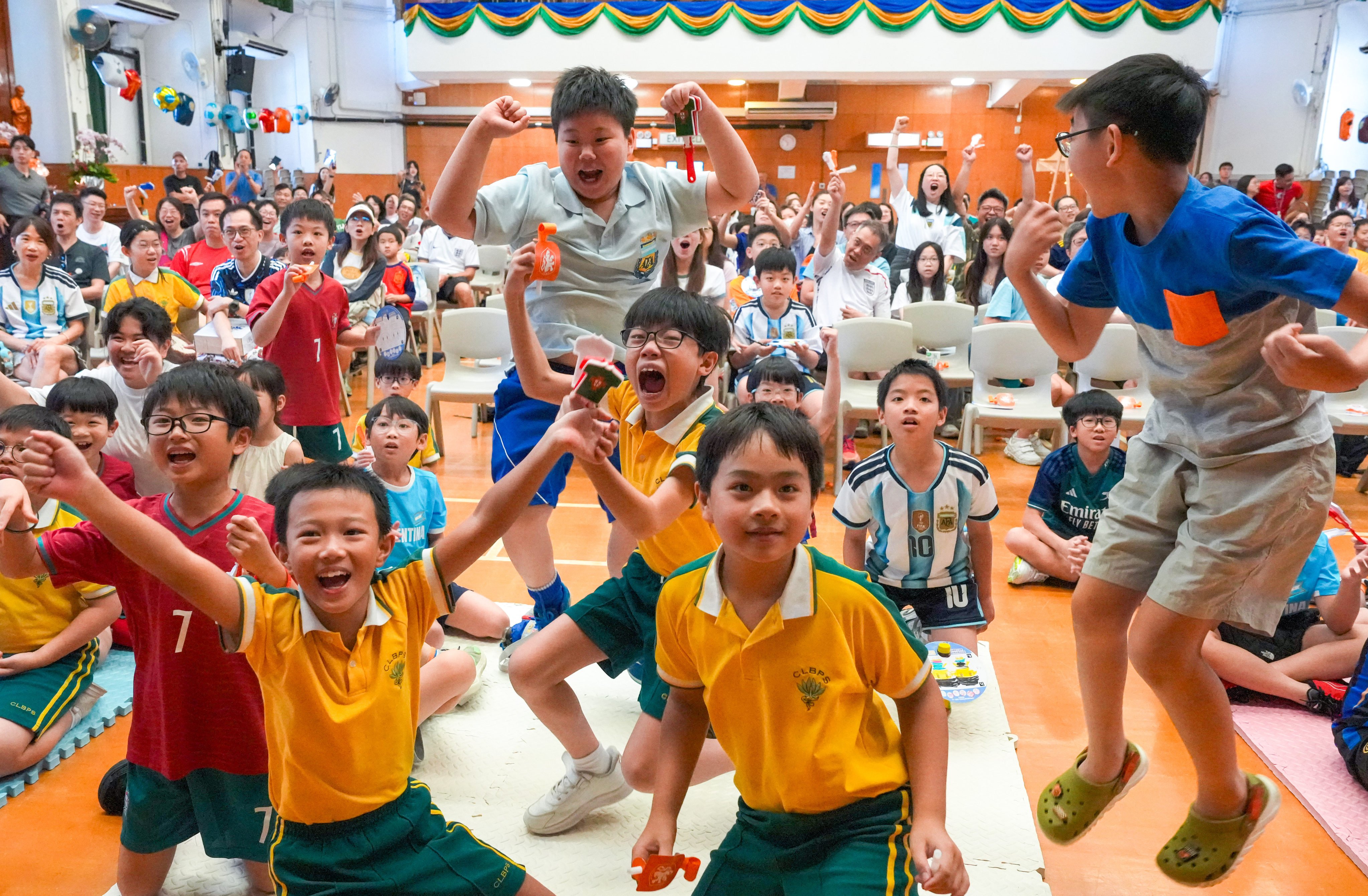 Students and parents at Buddhist Chi Lin Primary School enjoy a “Fun Day” World Cup watch party. Photo: Dickson Lee