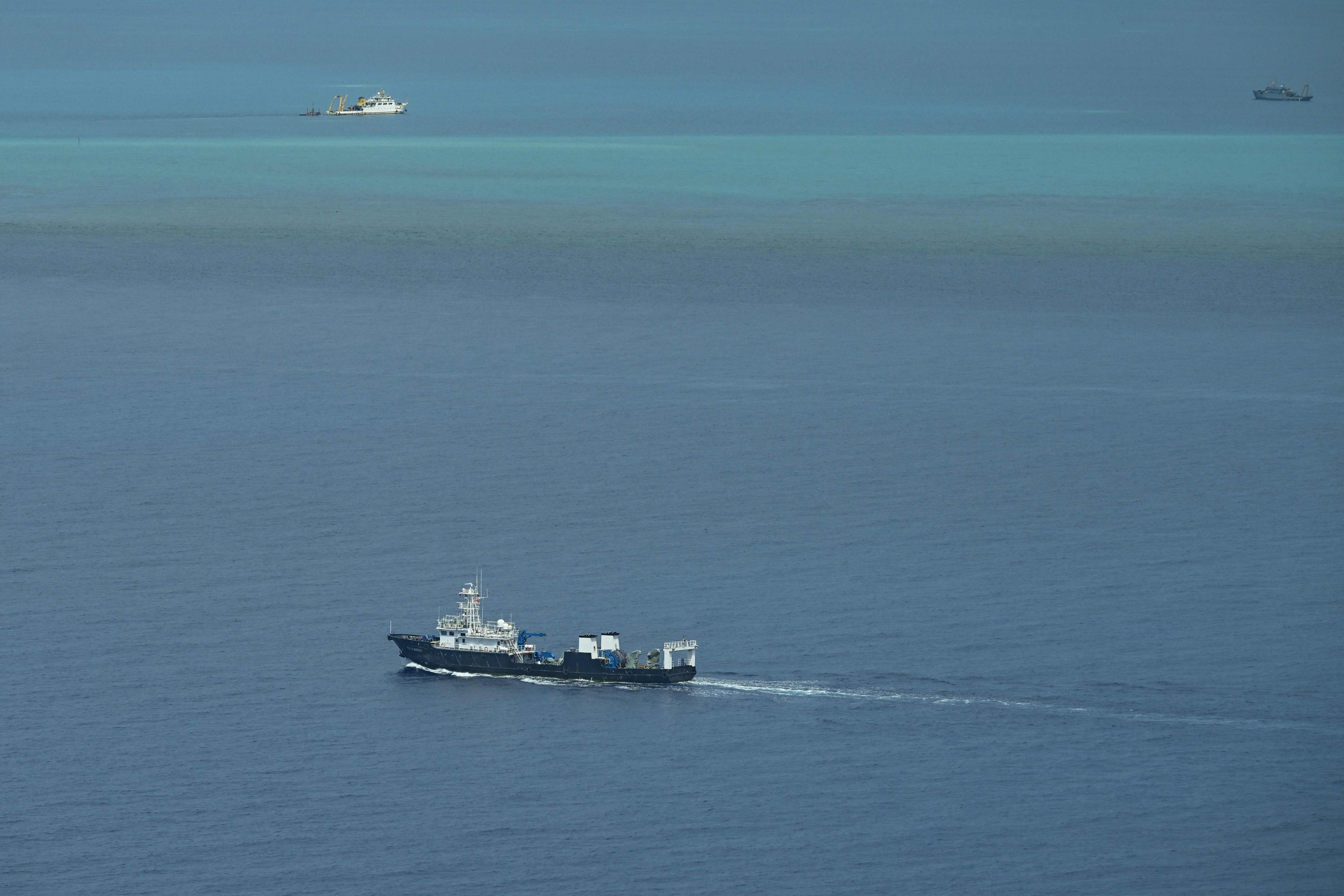 Ships identified by the Philippine Coast Guard as Chinese research vessels (left and right) and Chinese maritime militia (lower) at Scarborough Shoal in the disputed South China Sea on June 15. Photo: AFP