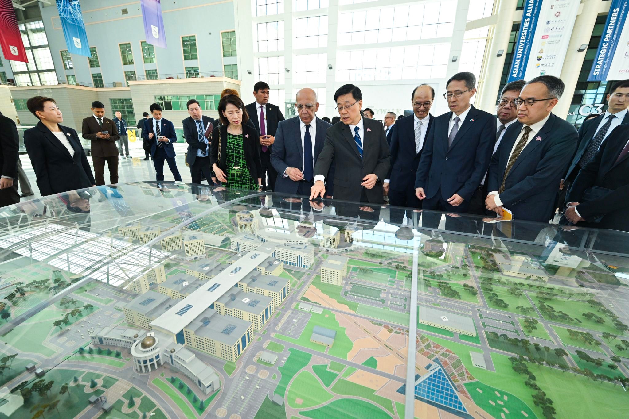 Hong Kong’s leader John Lee (centre, pointing) views a scale model at Nazarbayev University in Astana, Kazakhstan in early June. Photo: Handout