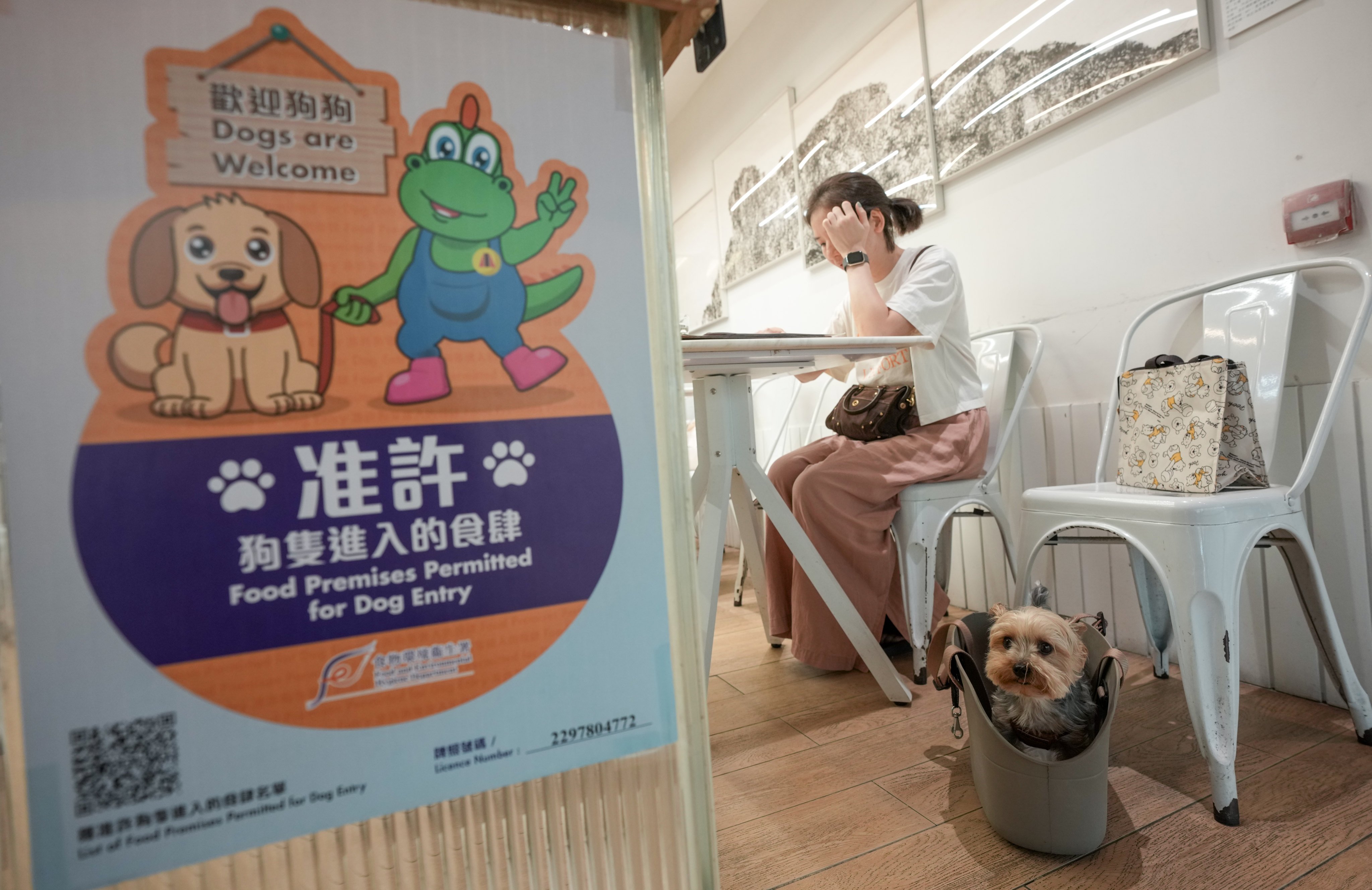 A woman with her dog in a restaurant at New Town Plaza in Sha Tin. Photo: Sam Tsang