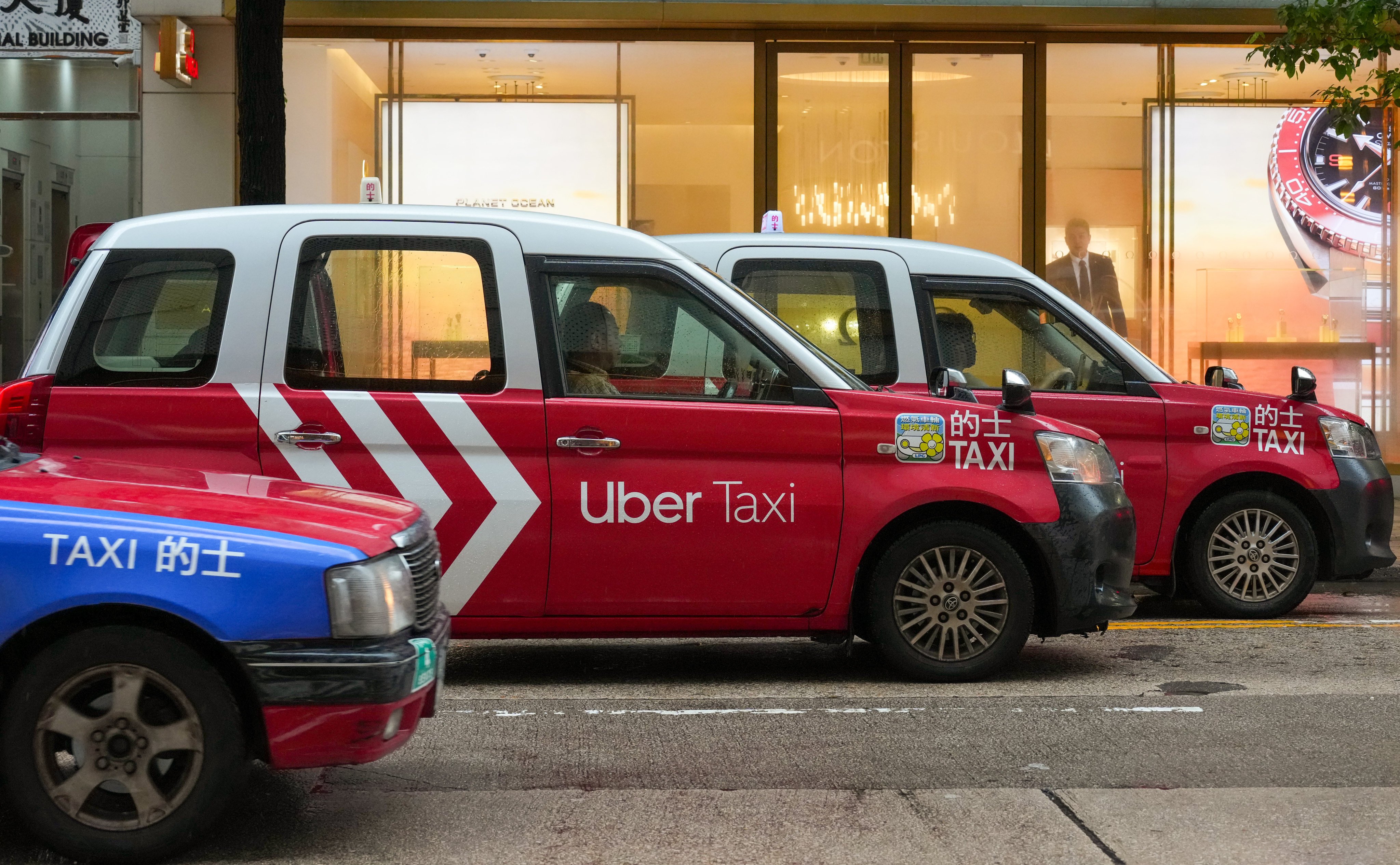 An Uber cab passes a taxi stand in Tsim Sha Tsui. Photo: Jelly Tse
