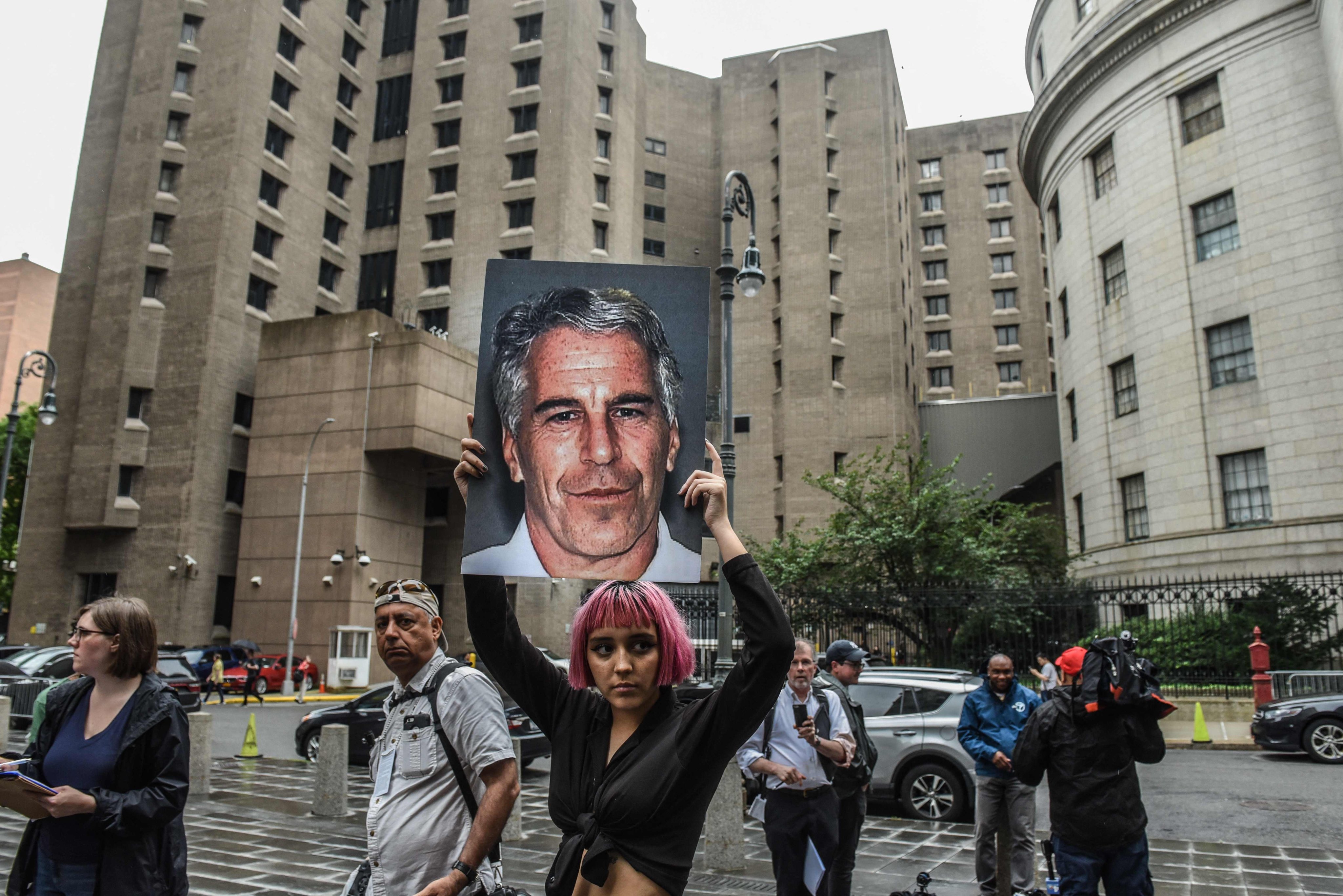 A protester holds up an image of Jeffrey Epstein in front of the Metropolitan Correction Centre in New York in July 2019. Photo: AFP