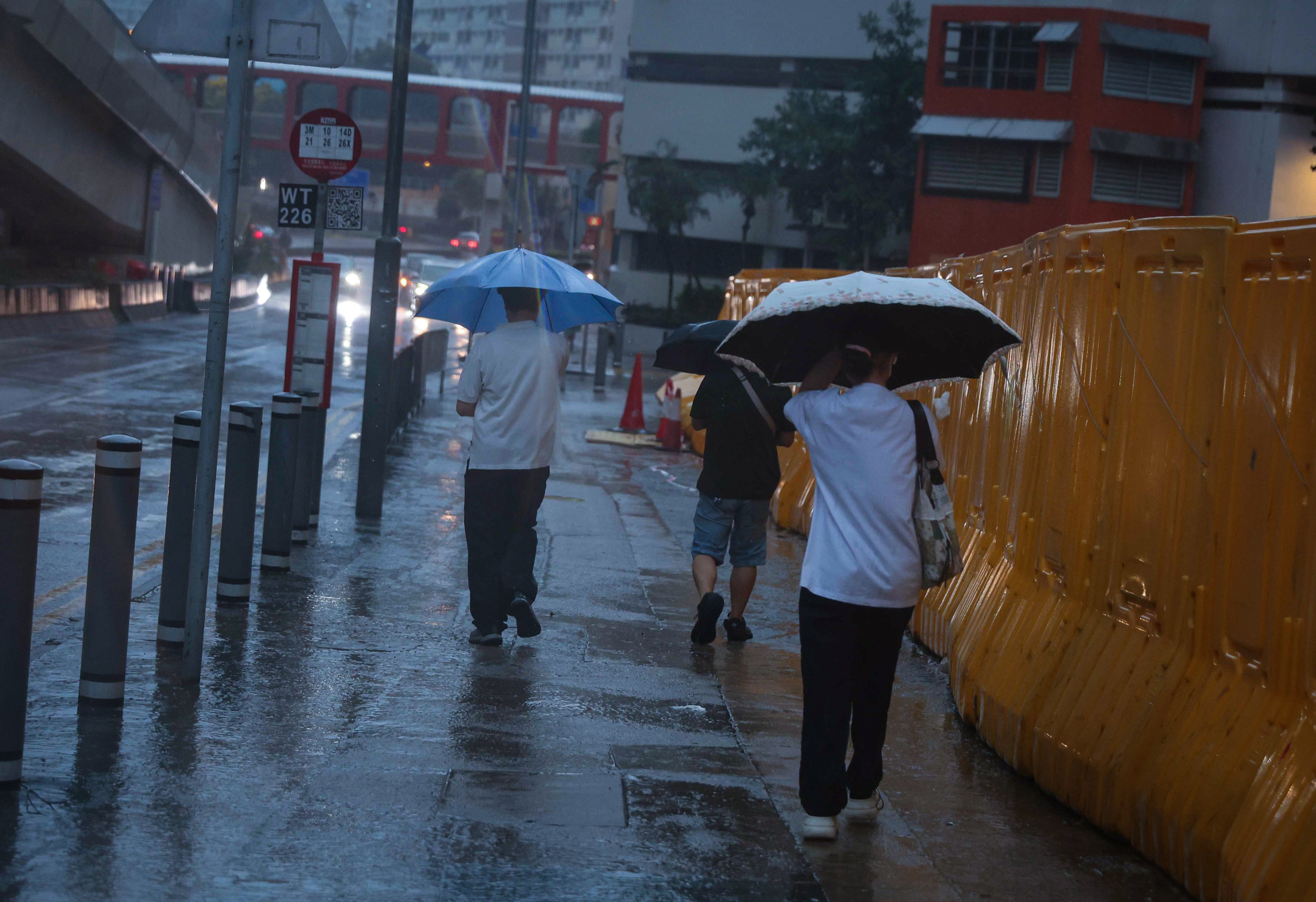 Residents brave the bad weather on Sunday morning. Photo: Edmond So