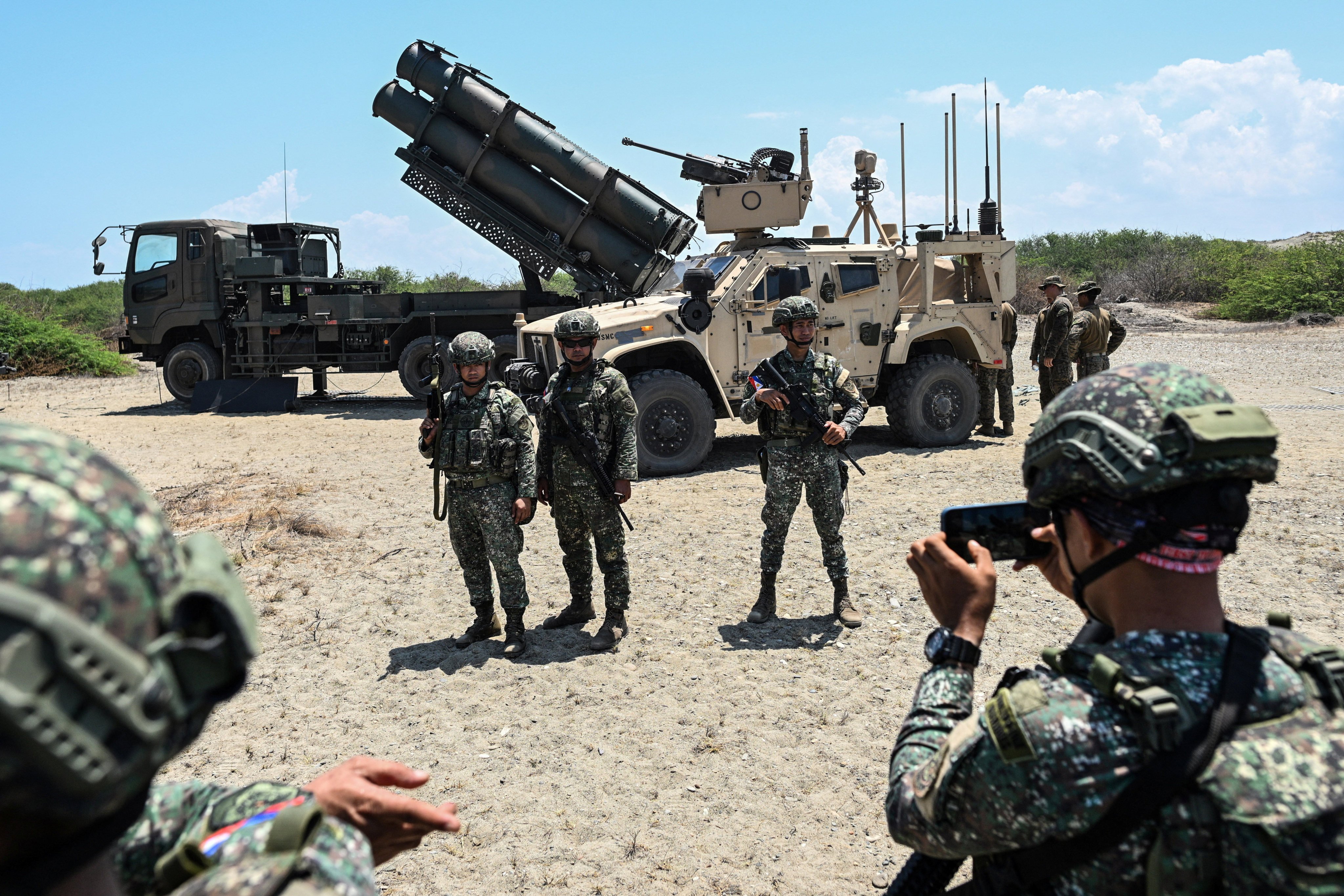 Philippine soldiers pose for a picture in front of the Japanese military’s Type 88 surface-to-ship missile launcher and the US Marine Air Defence Integrated System during the Balikatan joint military exercises at Paoay, Ilocos Norte province, in May. Photo: Reuters