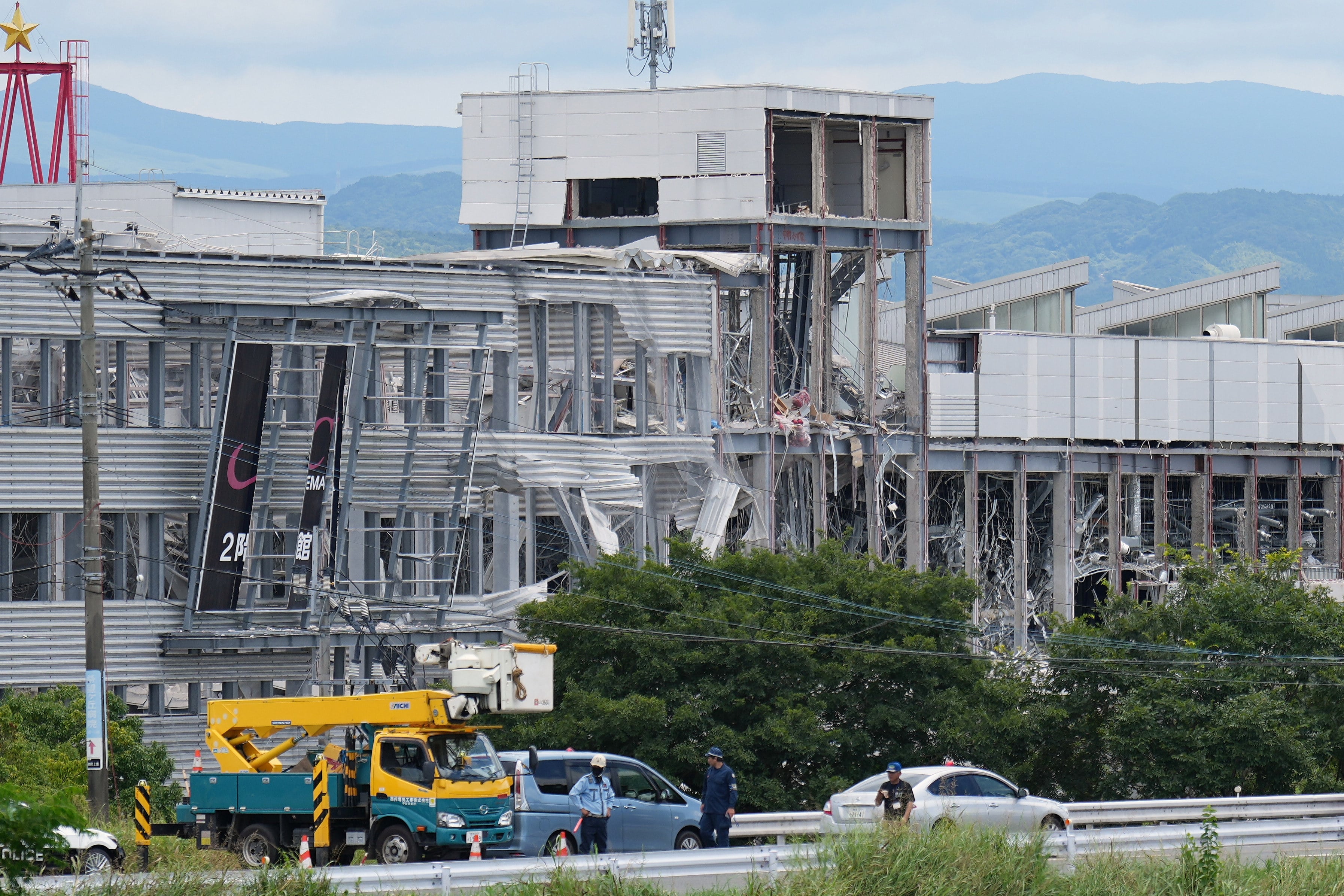 Rescuers stand outside Aeon Mall, which was destroyed by an explosion following an earthquake in Kashima, Kumamoto prefecture, on Wednesday. Photo: AP