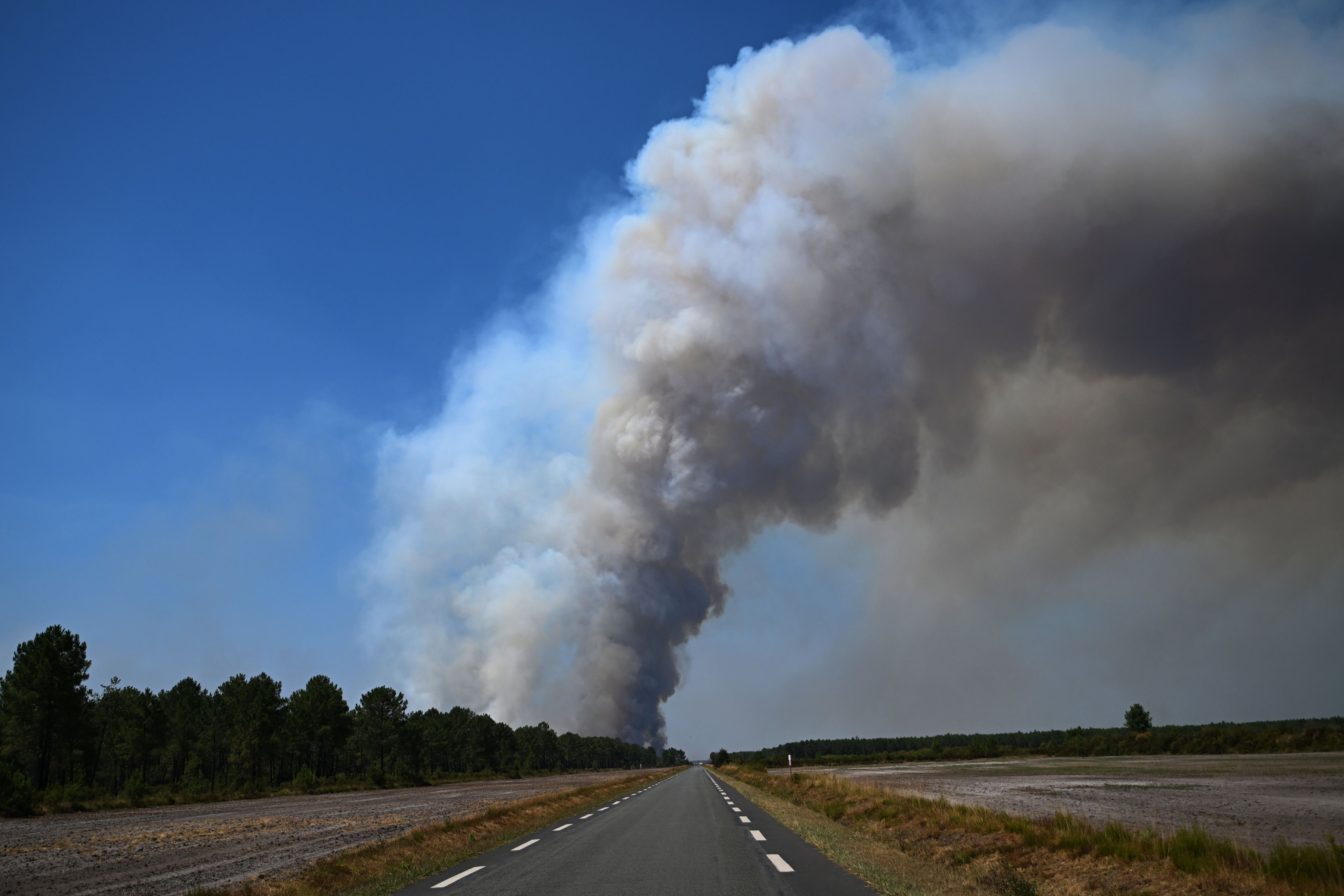 Smoke rises above a road near Saint-Jean-d’Illac, during wildfires in southwestern France on Tuesday. Photo: AP