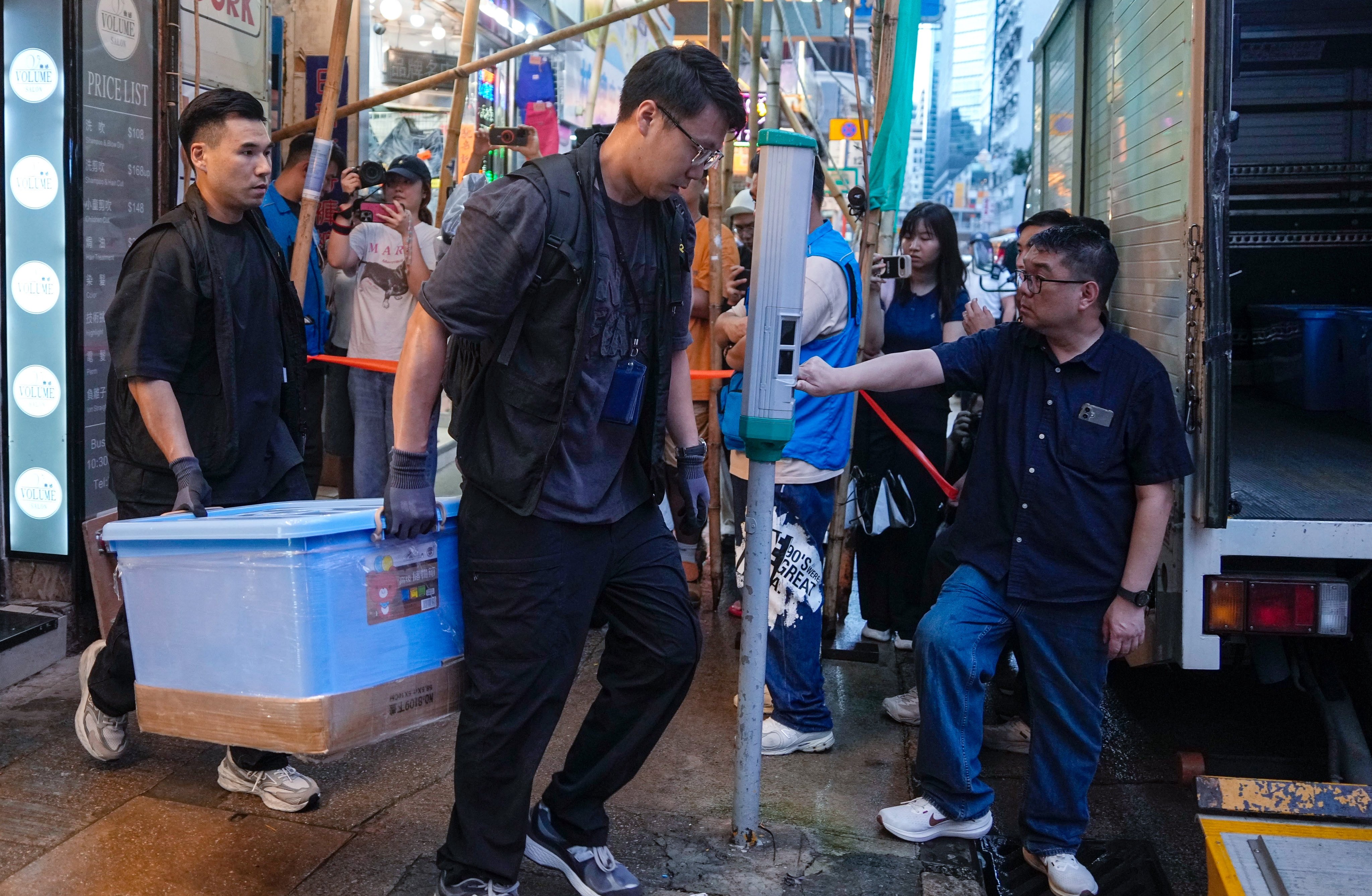 Police carry away evidence from the Have A Nice Stay bookshop in Prince Edward. The business and Greenfield Book Store were raided earlier this month. Photo: Handout