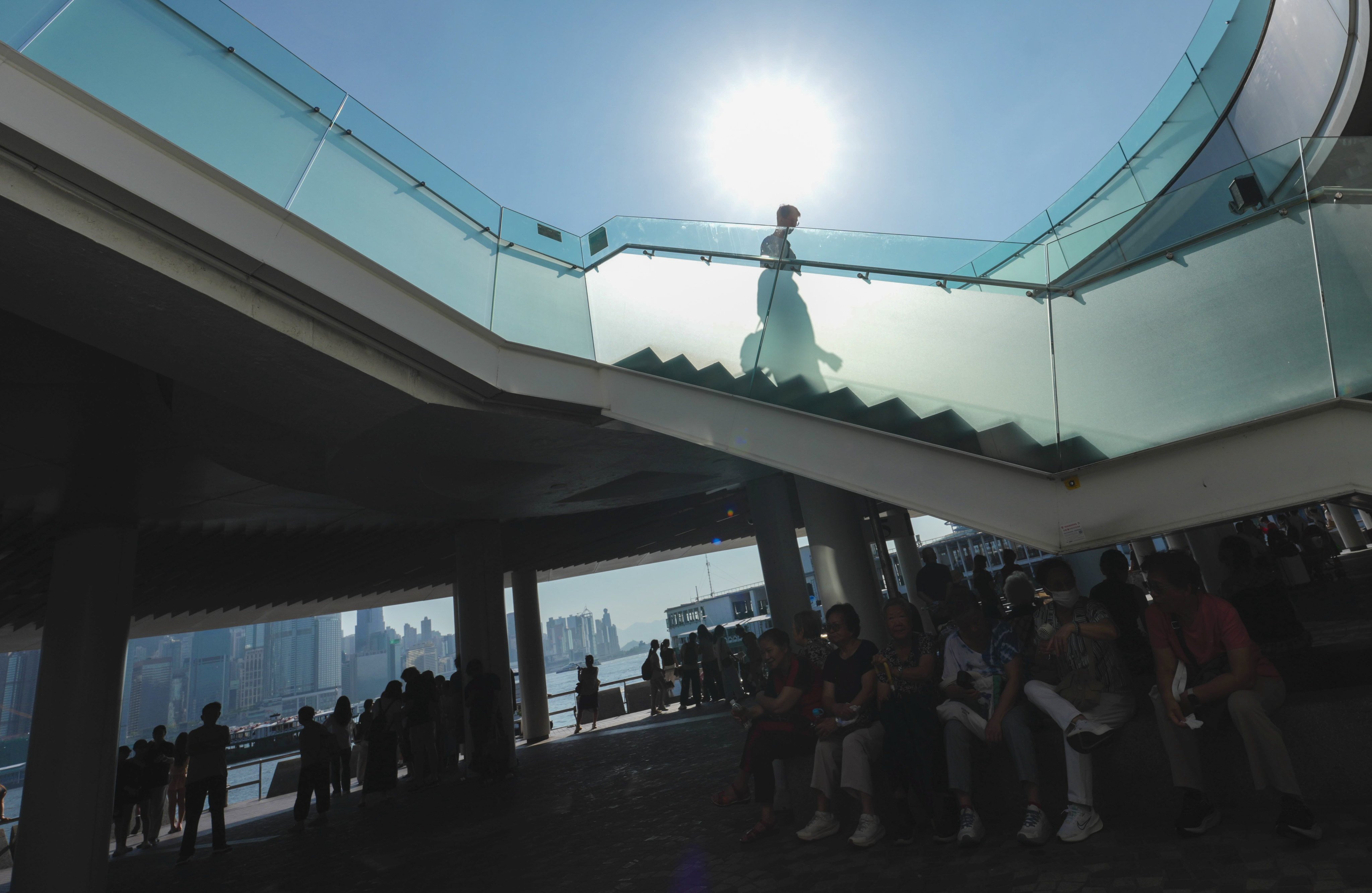 Tourists visit the Tsim Sha Tsui waterfront in extremely hot weather on July 24, ahead of Typhoon Noul. Photo: Jelly Tse